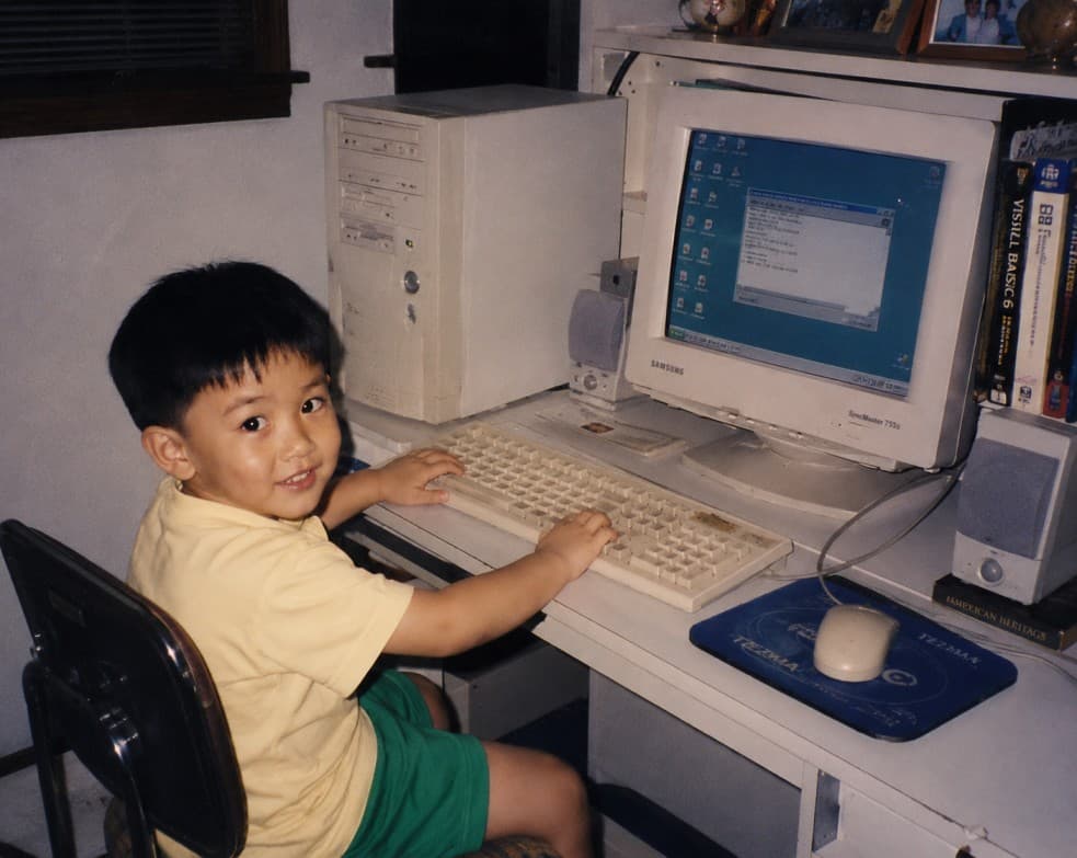 Brian as a child sitting at a family computer.