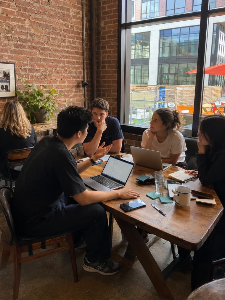 Brian in discussion with startup colleagues around a table.